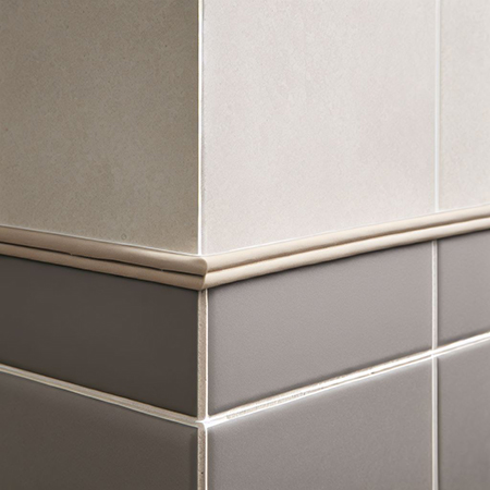 A ceramic tile trim finishing metro tiles on a wall